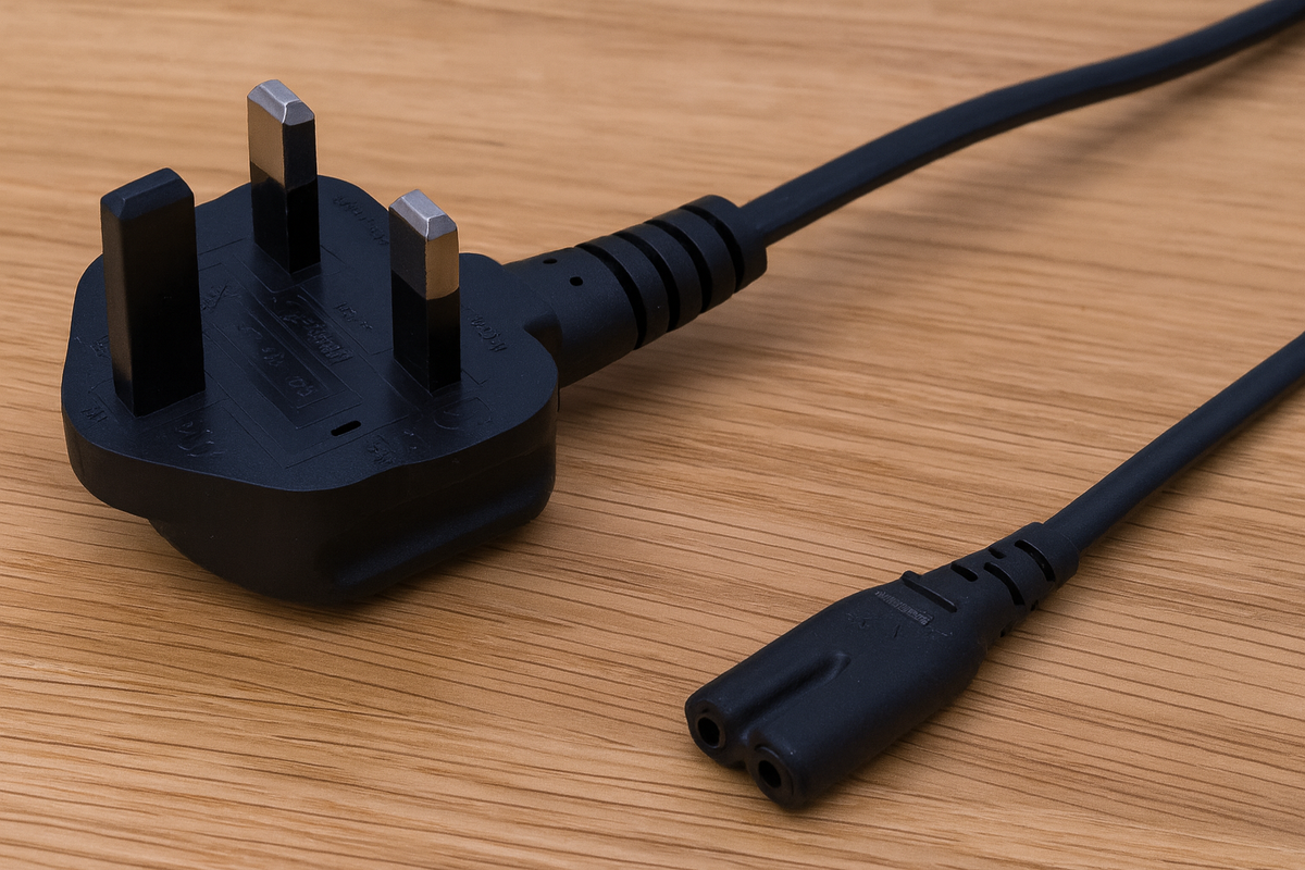 Black electrical plug and cable on a wooden surface
